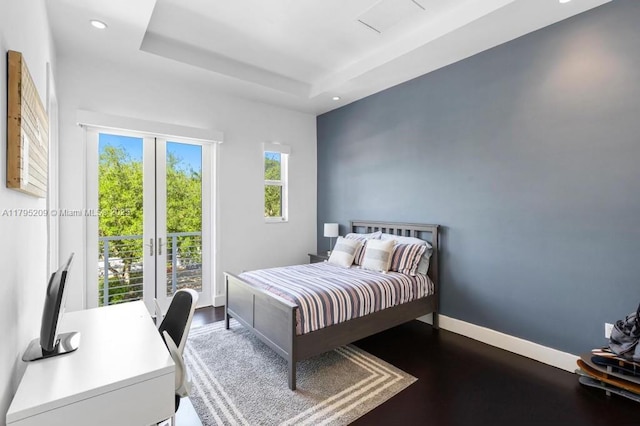 bedroom with recessed lighting, baseboards, and a tray ceiling