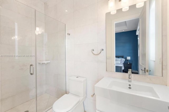 full bath featuring vanity, toilet, tile walls, ensuite bathroom, and a stall shower