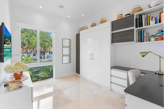 interior space featuring recessed lighting and marble finish floor