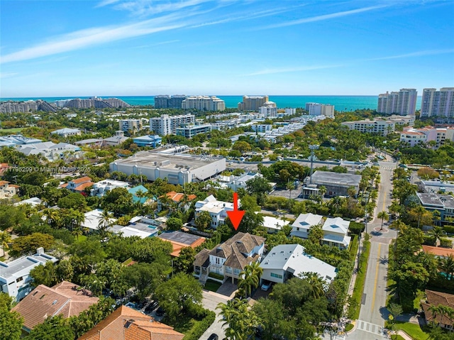 drone / aerial view featuring a water view and a city view