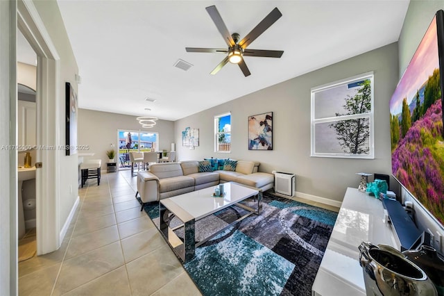 living room featuring visible vents, a ceiling fan, baseboards, and tile patterned flooring