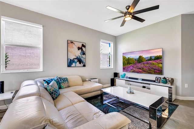 living room featuring ceiling fan and baseboards