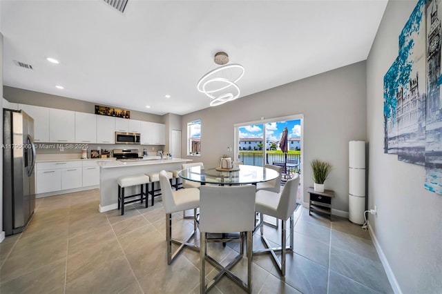 dining space featuring recessed lighting, baseboards, light tile patterned floors, and visible vents