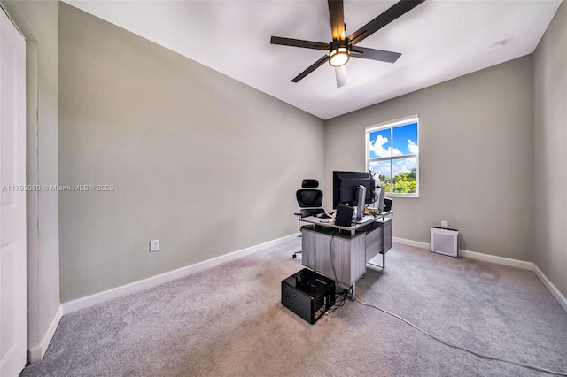 office space with light colored carpet, baseboards, and ceiling fan
