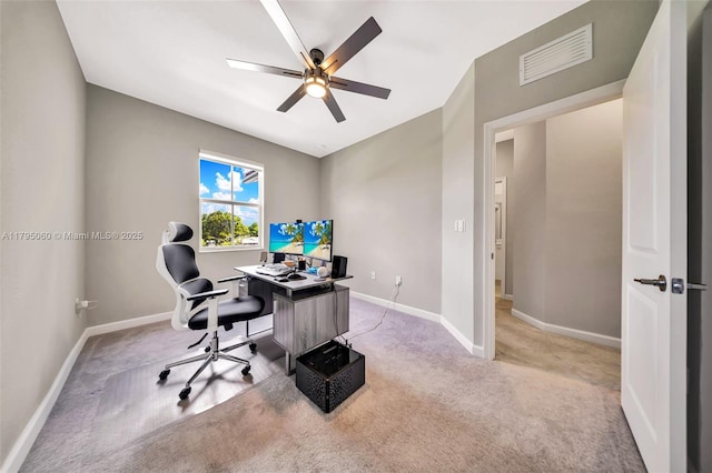 office area with light colored carpet, baseboards, visible vents, and ceiling fan
