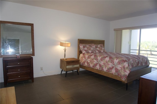 bedroom with baseboards and access to exterior