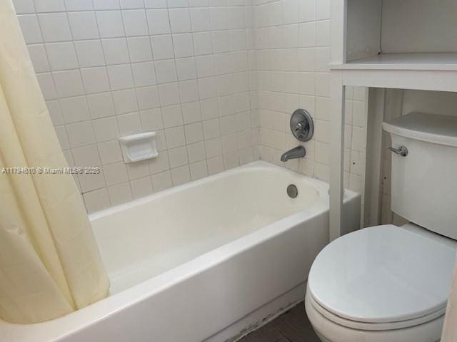 full bathroom with toilet and shower / bath combo with shower curtain