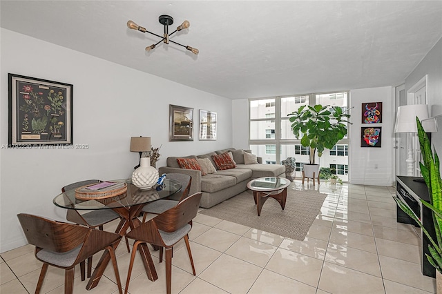 living area featuring light tile patterned flooring, a chandelier, and a wall of windows