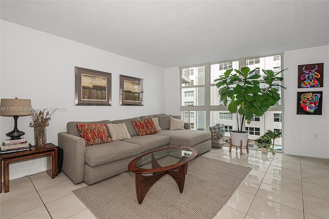 living room with floor to ceiling windows and light tile patterned flooring
