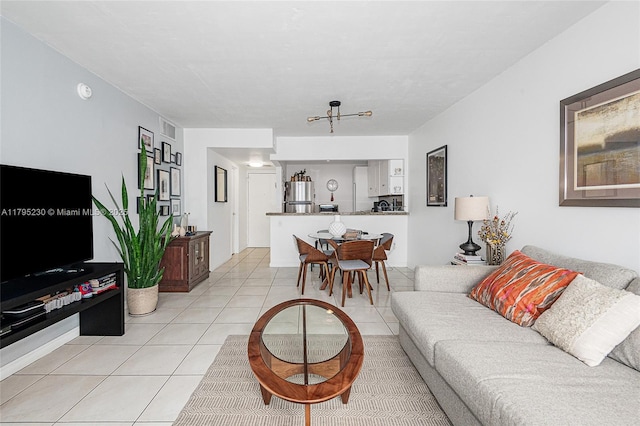 living area with visible vents and light tile patterned floors