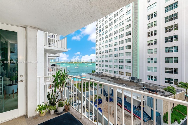 balcony with a water view and a city view