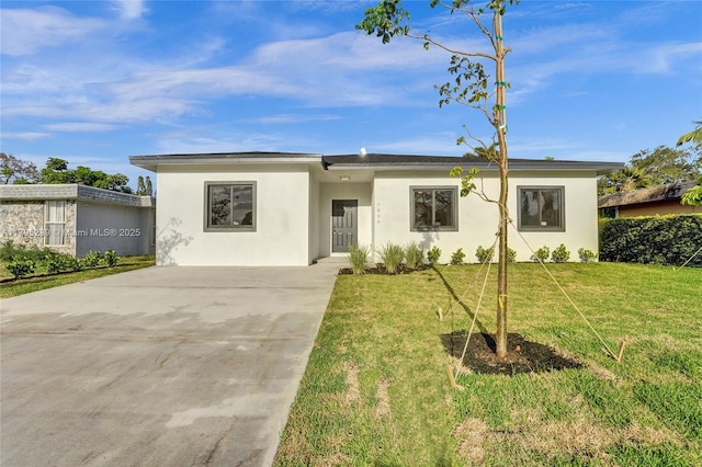 7806 NW 68th Ave, Tamarac, FL 33321 - view of front of property with stucco siding, driveway, and a front lawn