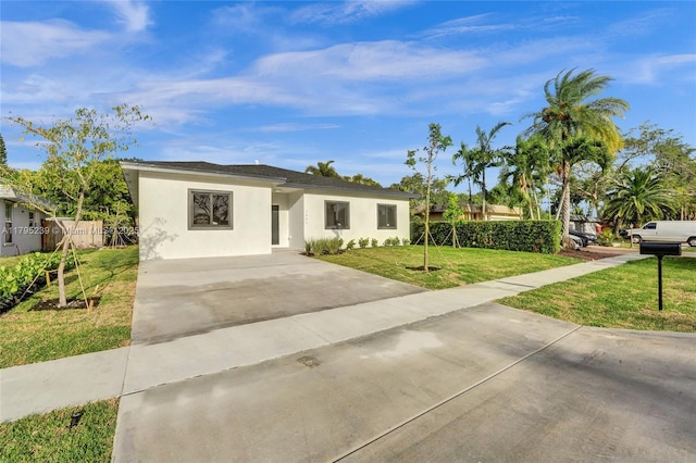 7806 NW 68th Ave, Tamarac, FL 33321 - view of front of house with a front lawn, stucco siding, and driveway