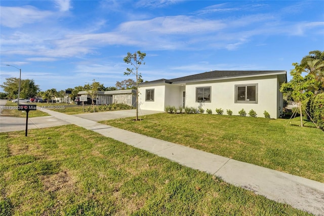 7806 NW 68th Ave, Tamarac, FL 33321 - view of front of property with a front yard and stucco siding