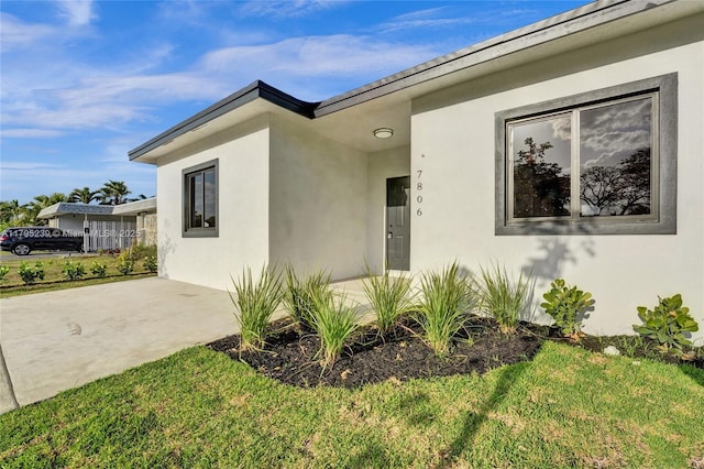 7806 NW 68th Ave, Tamarac, FL 33321 - view of front facade featuring a front lawn and stucco siding
