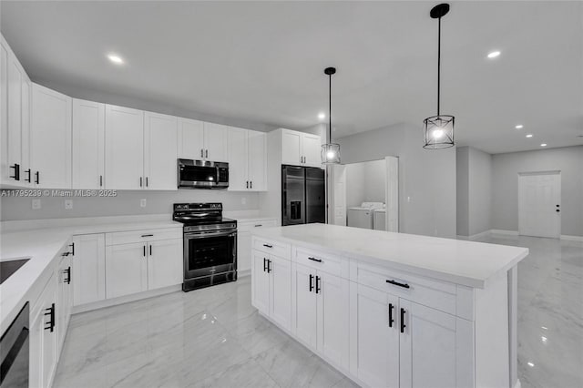7806 NW 68th Ave, Tamarac, FL 33321 - kitchen with a center island, marble finish floor, appliances with stainless steel finishes, and washing machine and dryer