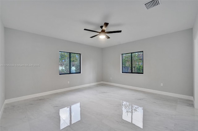 7806 NW 68th Ave, Tamarac, FL 33321 - empty room featuring a healthy amount of sunlight, visible vents, a ceiling fan, and marble finish floor