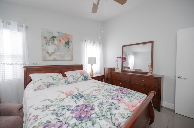 bedroom with baseboards, a ceiling fan, and light tile patterned flooring