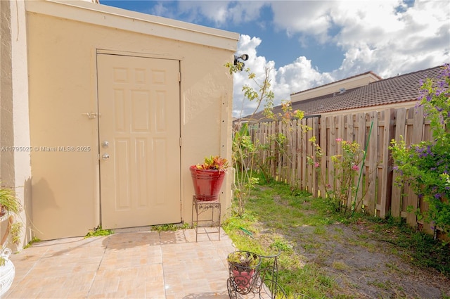 view of outbuilding featuring fence