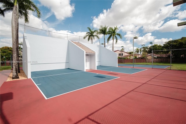 view of basketball court with fence and community basketball court