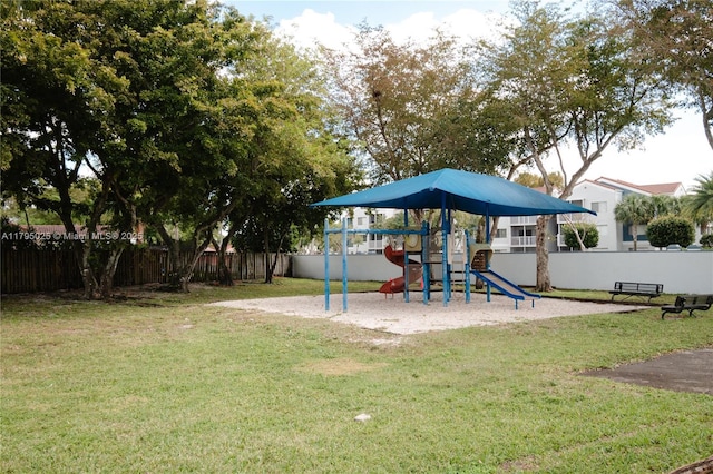 communal playground with fence and a lawn