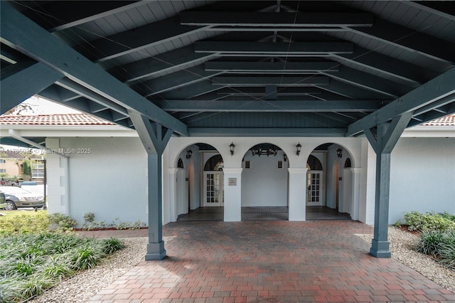 entrance to property featuring french doors and stucco siding