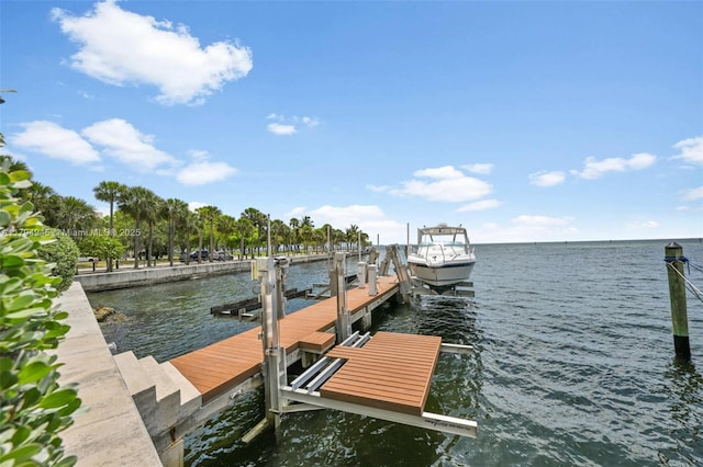 view of dock with boat lift and a water view