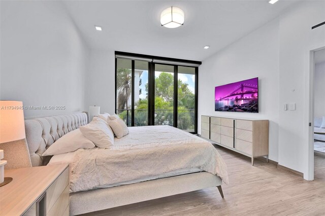 bedroom with recessed lighting, baseboards, floor to ceiling windows, and light wood-type flooring