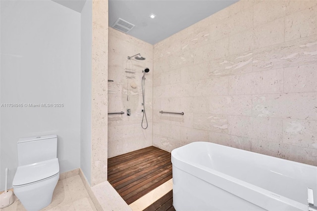 bathroom featuring toilet, a freestanding tub, visible vents, and tiled shower