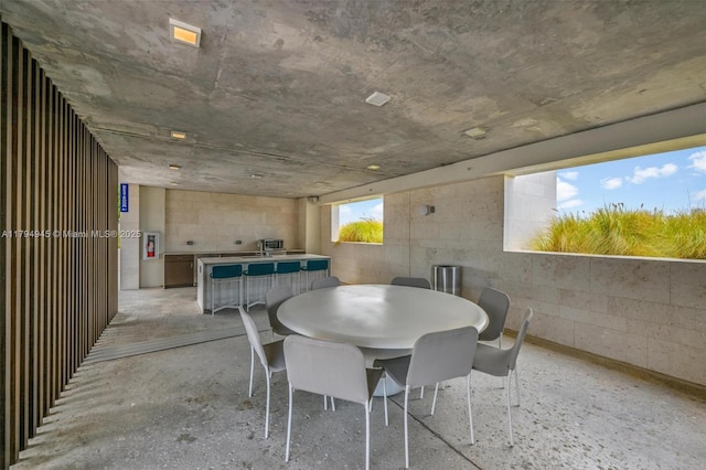 dining room with concrete block wall