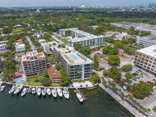 drone / aerial view featuring a city view and a water view