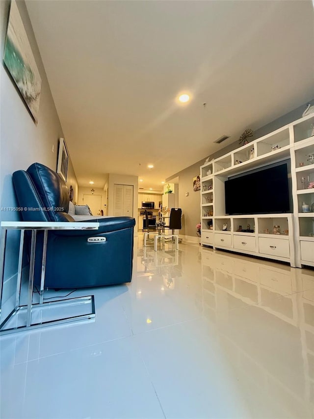 tiled living room featuring visible vents and recessed lighting