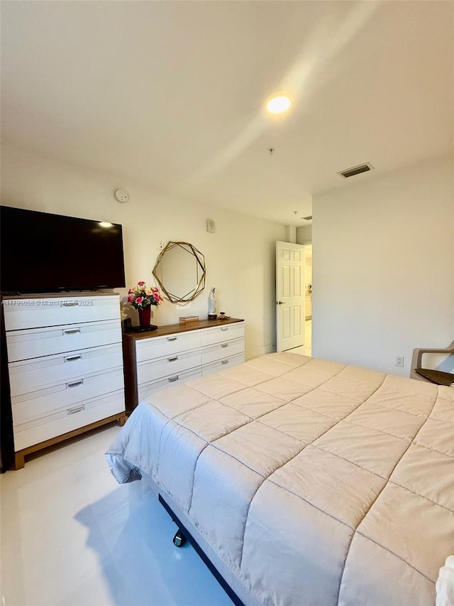 bedroom with concrete flooring and visible vents