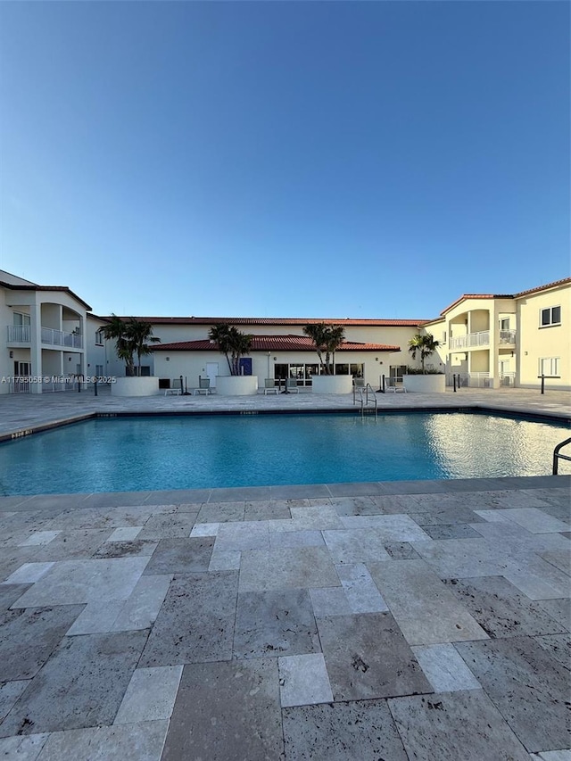 outdoor pool featuring a patio area