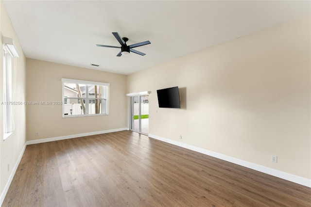 unfurnished living room with baseboards, a ceiling fan, visible vents, and wood finished floors