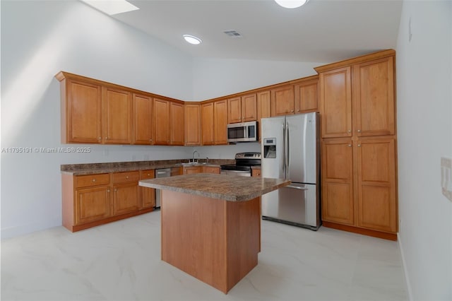 5926 Golden Eagle Cir, Palm Beach Gardens, FL 33418 - kitchen featuring appliances with stainless steel finishes, a center island, brown cabinetry, and high vaulted ceiling