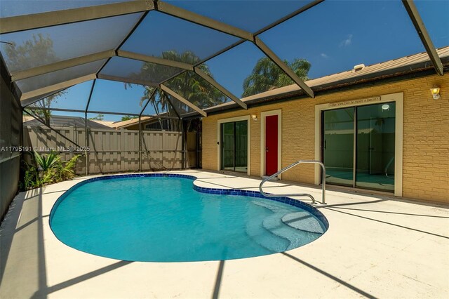 5926 Golden Eagle Cir, Palm Beach Gardens, FL 33418 - view of pool featuring a patio area and glass enclosure
