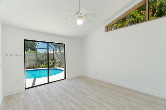 5926 Golden Eagle Cir, Palm Beach Gardens, FL 33418 - unfurnished room featuring ceiling fan, wood finished floors, lofted ceiling, baseboards, and a sunroom
