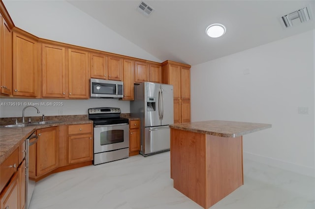 5926 Golden Eagle Cir, Palm Beach Gardens, FL 33418 - kitchen featuring stainless steel appliances, lofted ceiling, a sink, a center island, and brown cabinets