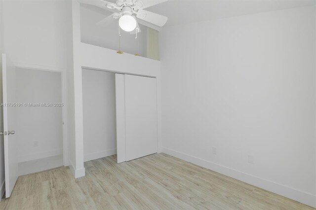 5926 Golden Eagle Cir, Palm Beach Gardens, FL 33418 - unfurnished bedroom featuring wood finished floors, baseboards, a closet, and ceiling fan