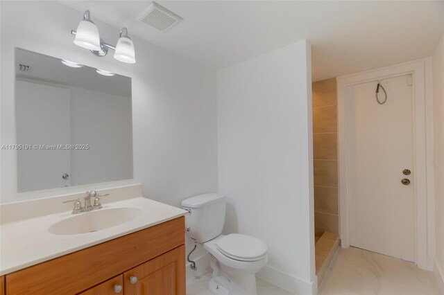 5926 Golden Eagle Cir, Palm Beach Gardens, FL 33418 - bathroom featuring toilet, vanity, and a tile shower