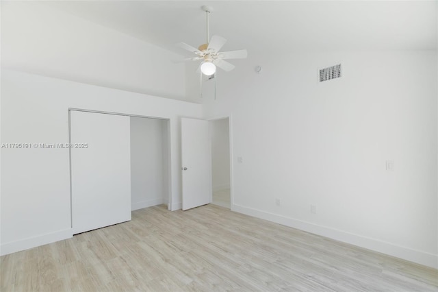 5926 Golden Eagle Cir, Palm Beach Gardens, FL 33418 - unfurnished bedroom featuring high vaulted ceiling, light wood finished floors, baseboards, a closet, and a ceiling fan