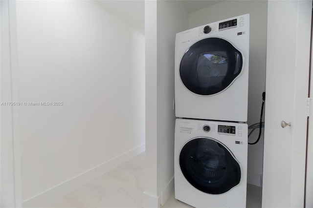 5926 Golden Eagle Cir, Palm Beach Gardens, FL 33418 - laundry area with stacked washer and clothes dryer, baseboards, and light marble finish flooring
