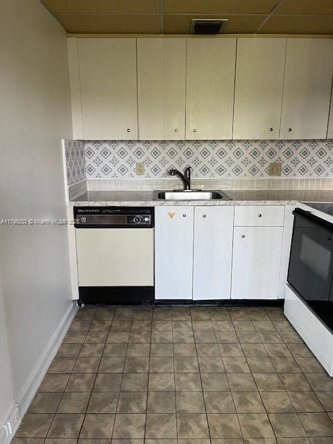 kitchen featuring a sink, stove, dishwasher, and decorative backsplash