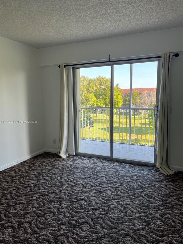 13250 SW 7th Ct Unit 402L, Pembroke Pines, FL 33027 - carpeted empty room featuring baseboards and a textured ceiling