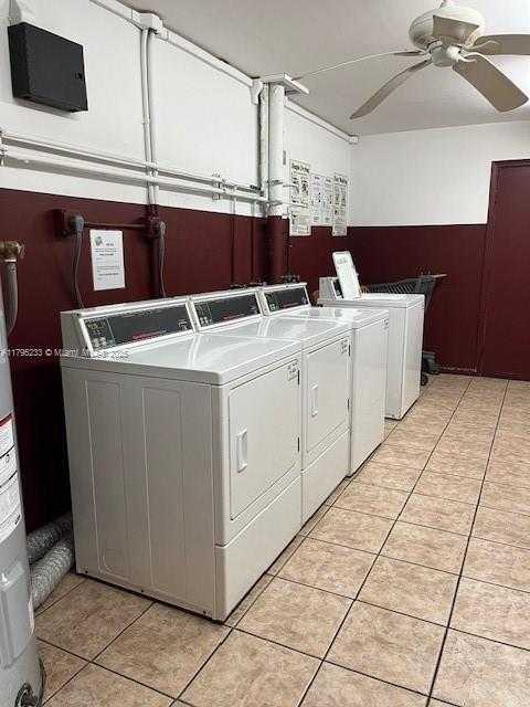 common laundry area featuring independent washer and dryer, water heater, light tile patterned flooring, and ceiling fan