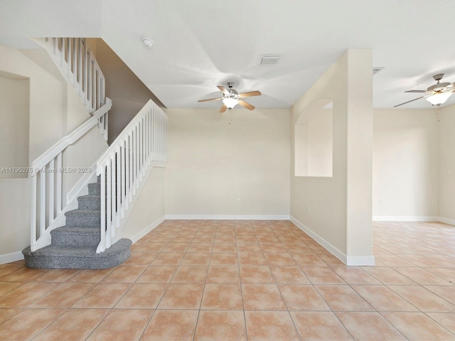 interior space featuring stairs, a ceiling fan, visible vents, and light tile patterned floors