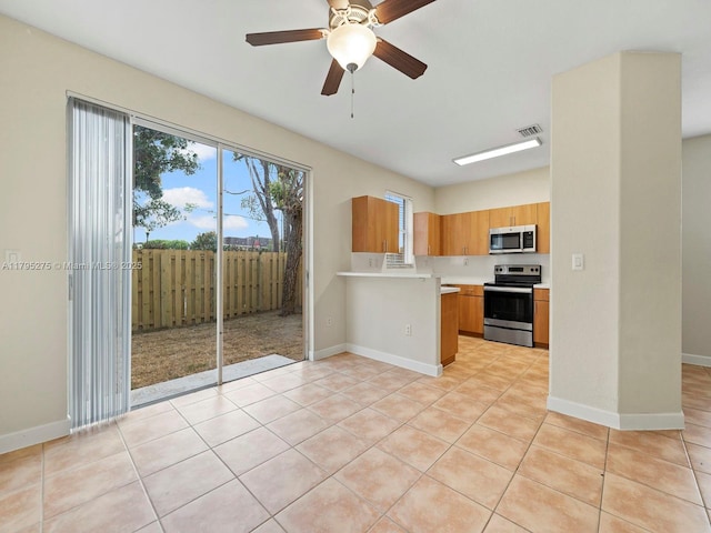 kitchen with light countertops, visible vents, stainless steel appliances, and a wealth of natural light