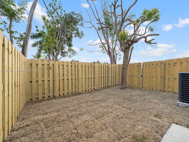view of yard featuring a fenced backyard and cooling unit