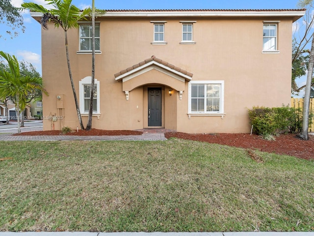view of front facade featuring a front lawn and stucco siding